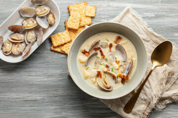 Clam chowder. Traditional American cream soup with clams,  potatoes, bacon, carrots, and onions