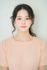 Elegant Young Woman in Soft Pastel Dress with Natural Makeup