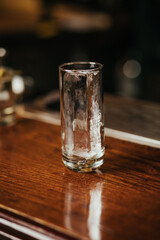 Crystal clear ice cube in a glass on a bar