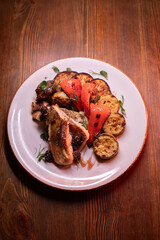 Restaurant dish fish with vegetables: zucchini, pepper