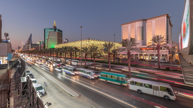 Aerial day to night timelapse of King Fahd Road near the illuminated Riyadh National Library in Riyadh, Saudi Arabia.