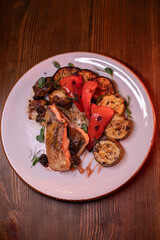 Restaurant dish fish with vegetables: zucchini, pepper