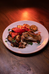 Restaurant dish fish with vegetables: zucchini, pepper