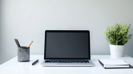 Fototapeta premium Minimalist workspace setup with open laptop on clean white desk, modern business productivity concept for remote work and professional efficiency