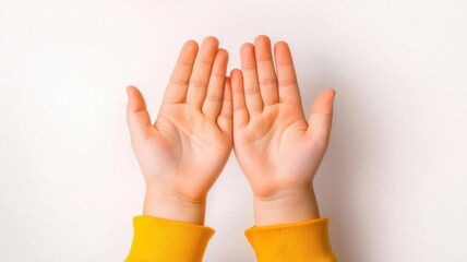 Obraz premium Autism spectrum disorder. Open hands in a welcoming gesture, wearing a yellow sweater against a light background.
