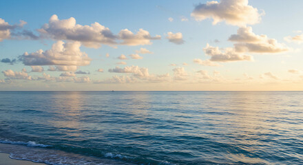 Obraz premium Calm Weather Over the Sea or Ocean, with Soft Clouds Drifted Across the Sky, Creating a Peaceful and Tranquil Seascape