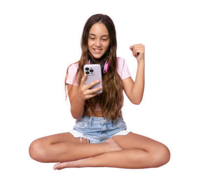 Little girl sitting on the floor, using a smartphone and listening to the music. Side view. Full length studio shot isolated over transparent background.