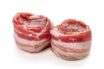 Raw Pork medallions wrapped in bacon, isolated on white background.