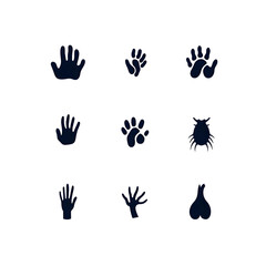 Fototapeta premium Collection of Handprints and Animal Paw Prints in Dark Silhouette Style