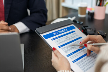 A man and a woman are looking at a car on a table. The man is pointing at the car and the woman is holding a pen. Concept of a car being sold or discussed, and the mood is serious

