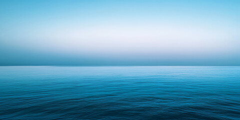 Obraz premium A soft gradient blue background, transitioning from light azure at the top to a deep royal blue at the bottom. The gentle fade creates a serene and peaceful atmosphere, perfect for creative designs or