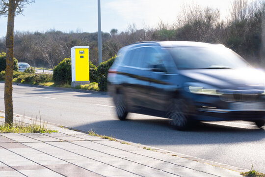 Fixed speed camera fines a car for speeding. new radars with artificial intelligence. In Pamplona, Spain. Painted in fluorescent yellow for easy visibility.