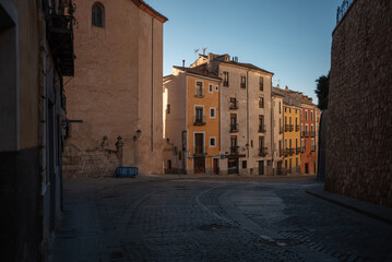 cozy street of ancient European town, sunset over historic buildings