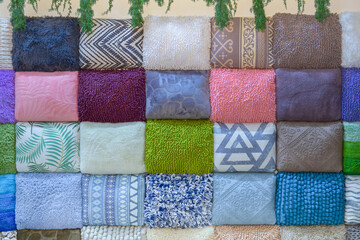 A background of rolled towels in different shades stacked in a tight pile