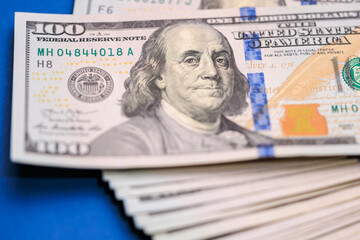 Close-up of a us 100 dollar bill featuring benjamin franklin portrait