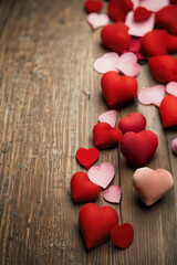 Fabric hearts on top of vintage wood. AI generated.