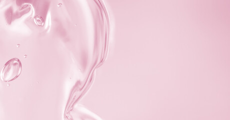 Abstract soft pink liquid with flowing texture and bubbles on a soft pastel background. Elegant and modern fluid composition. Copy space available. luxury pastel background for beauty products. Banner