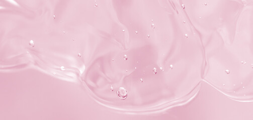 Abstract soft pink liquid with flowing texture and bubbles on a soft pastel background. Elegant and modern fluid composition. Copy space available. Banner