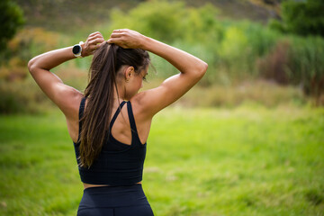 Obraz premium Young female athlete in black sportswear exercising outdoors in a scenic rural setting. Captured in various poses including stretching, jumping, and smiling, showcasing fitness, health.