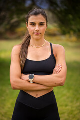 Fototapeta premium Young female athlete in black sportswear exercising outdoors in a scenic rural setting. Captured in various poses, including stretching, jumping, and smiling.
