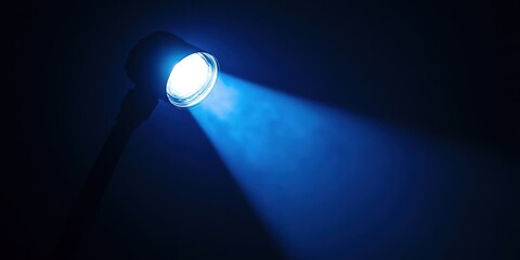 Blue light is shining on a dark background