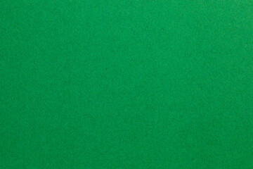 A green background with no visible objects, textured origami paper backdrop