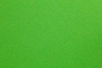A green field with grass and a few trees, textured origami paper backdrop
