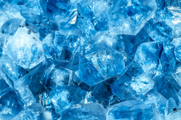 Blue Crystal Mineral Stone. Gems. Mineral crystals in the natural environment. Texture of precious and semiprecious stones. Seamless background with copy space colored shiny surface of precious stones