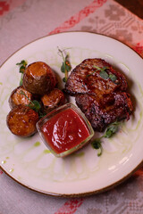 Beautiful restaurant dish golden potatoes and juicy meat, beautiful food photo