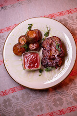 Beautiful restaurant dish golden potatoes and juicy meat, beautiful food photo