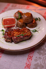 Beautiful restaurant dish golden potatoes and juicy meat, beautiful food photo