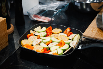 vegetables zucchini, tomatoes, eggplants are cooked in a grill pan