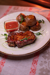 Beautiful restaurant dish golden potatoes and juicy meat, beautiful food photo