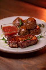 Beautiful restaurant dish golden potatoes and juicy meat, beautiful food photo