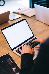 Unrecognizable man typing on laptop