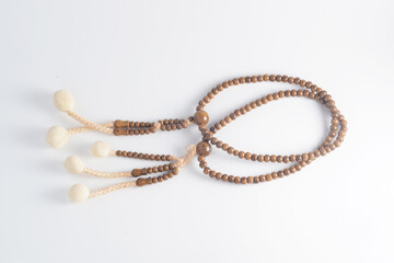 A wooden Juzu, a Japanese prayer beads, is a form of beadwork used to count the repetition of prayers, chants or mantras by members of various religions such as Buddhism and Shinto.