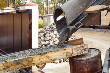 Pouring ready mixed concrete after placing steel reinforcement. construction. 