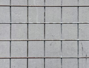 Wiremesh grid with concrete wall background