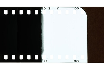 An empty vintage film negative, showing the beginning of the roll and a light-exposed section...