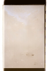 A blank vintage film negative frame with perforations on the sides, featuring a sepia-toned texture...