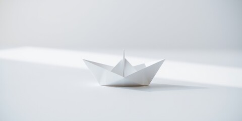 A solitary white origami boat floats on a minimalist white surface, bathed in soft, diffused light