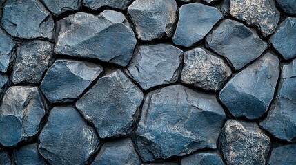 Fototapeta premium Close-up textured dark stone wall exterior