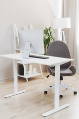 Modern office workspace featuring a sleek desk, ergonomic chair, and computer setup in a well-lit environment