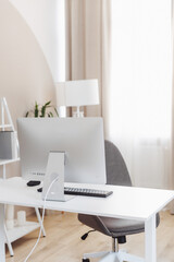 Modern office workspace featuring a sleek desk, ergonomic chair, and stylish decor in a bright and airy environment