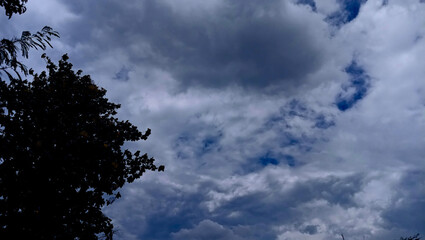 The sky is dramatic with nimbostratus clouds signaling rain.