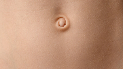 Close-up of a baby's navel on smooth skin. Detailed skin texture, natural color, and soft lighting...