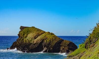 Fototapeta premium Miradouro do Ilhéu de Rosto de Cão is a picturesque viewpoint on São Miguel, Azores, offering spectacular views of the Atlantic Ocean and a distinctive rock formation resembling a dog's face, surround