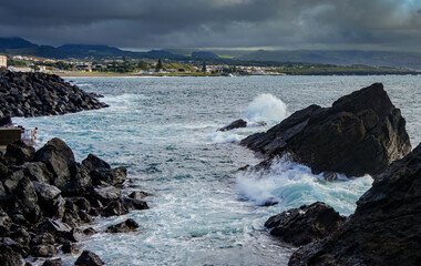 Swimming in the Atlantic Ocean, Porto de Pesca Corretora is a small fishing port on São Miguel Island, Azores, known for its traditional fishing boats, scenic coastal views, and authentic maritime 