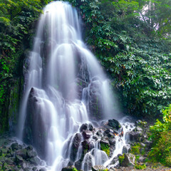 Ribeira dos Caldeirões is a stunning natural park on São Miguel Island, Azores, known for its lush greenery, picturesque waterfalls, historic watermills, and walking trails, offering visitors a serene