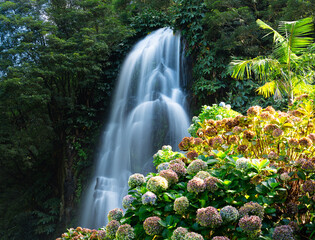 Ribeira dos Caldeirões is a stunning natural park on São Miguel Island, Azores, known for its lush greenery, picturesque waterfalls, historic watermills, and walking trails, offering visitors a serene